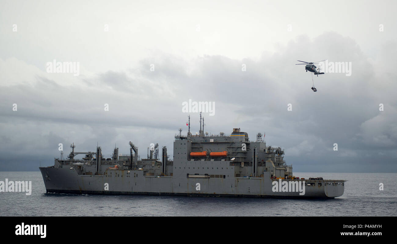 160626-N-BB534-305  PHILIPPINES SEA  (June 26, 2016) An MH-60S helicopter assigned to the Blackjacks of Helicopter Sea Combat Squadron (HSC) 21 lifts cargo off the deck of the dry cargo and ammunition ship USNS Richard E. Byrd (T-AKE 4) during a vertical replenishment with hospital ship USNS Mercy (T-AH 19). Mercy is currently deployed in support of Pacific Partnership 2016. Medical, engineering and various other personnel embarked aboard Mercy are working side-by-side with partner nation counterparts, exchanging ideas, building best practices and relationships to ensure preparedness should di Stock Photo