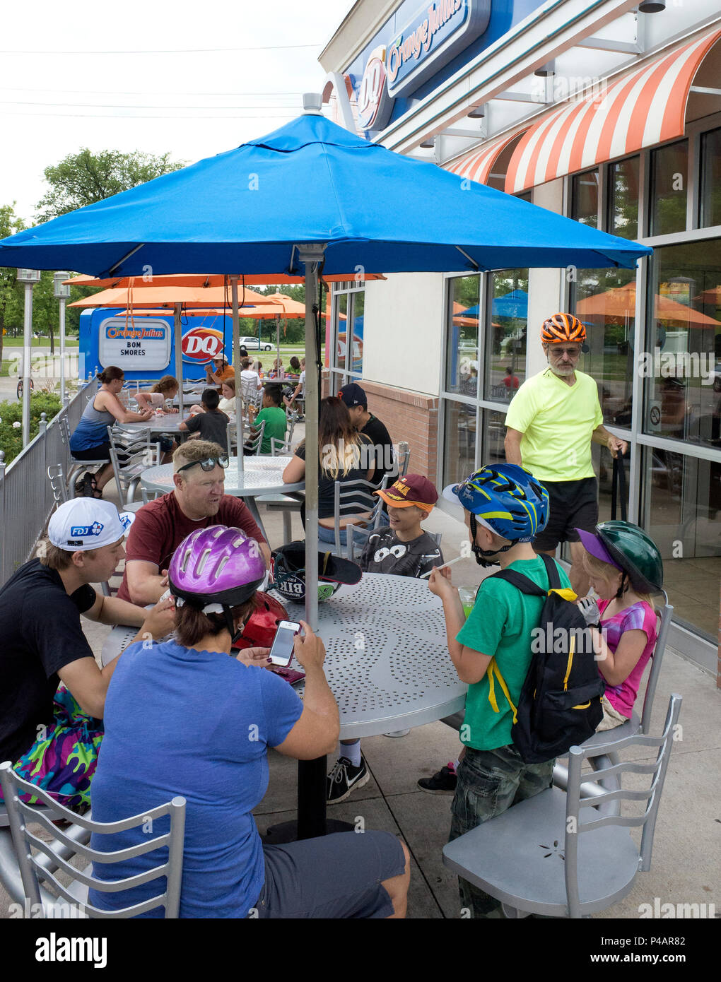 Diners enjoying a summer day under umbrellas on the Dairy Queen DQ