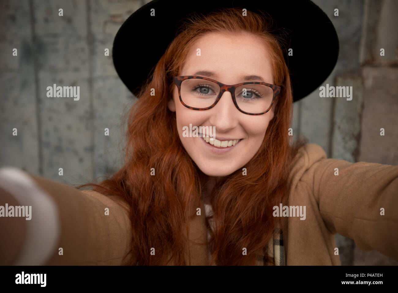 Woman relaxing on a sidewalk in the city Stock Photo