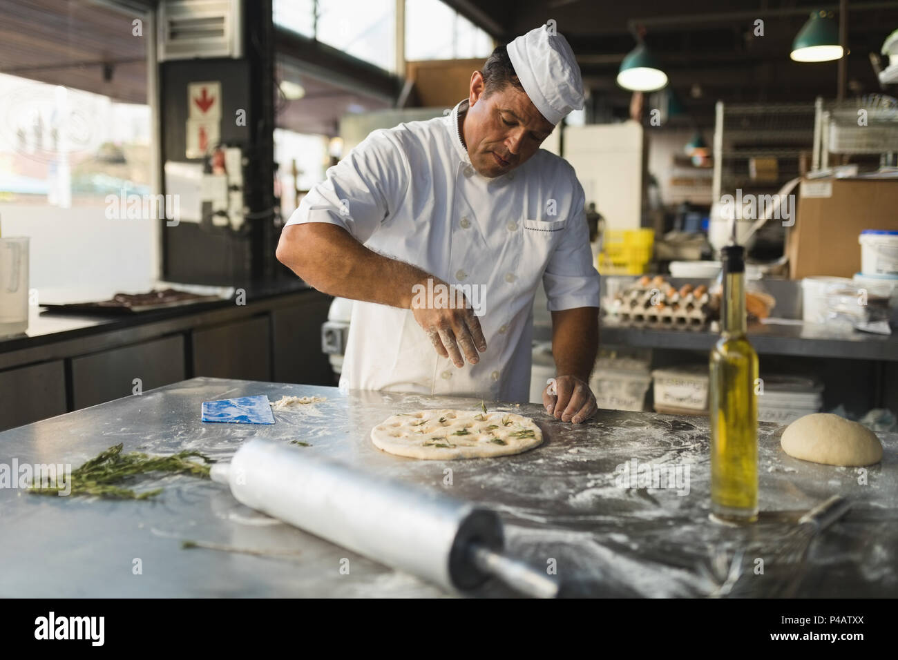 Male baker preparing dough in bakery shop Stock Photo