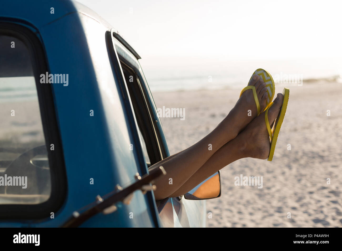 Woman relaxing with feet up in a pickup truck Stock Photo