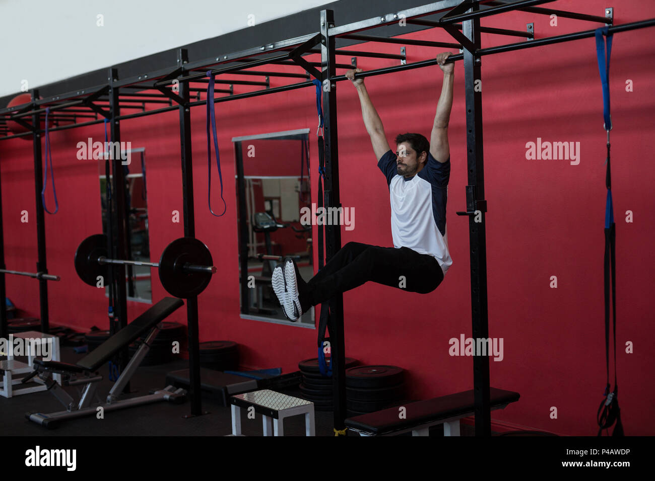 Athlete exercising on monkey bar Stock Photo Alamy