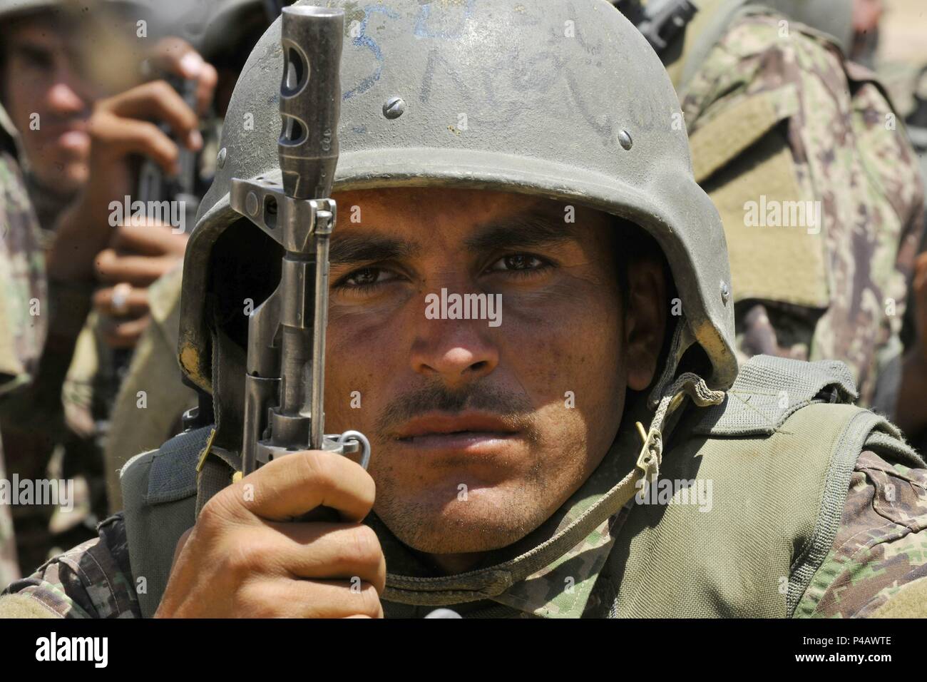 An Afghan National Army-Territorial Force member watches security demonstrations during an exercise at the Kabul Military Training Center in Kabul, Afghanistan, June 11, 2018, June 11, 2018. Demonstrations consisted of security checkpoint procedures, medical evacuations, Improvised Explosive Device detection, and concealment. (U.S. Air Force photo by Tech. Sgt. Sharida Jackson). () Stock Photo