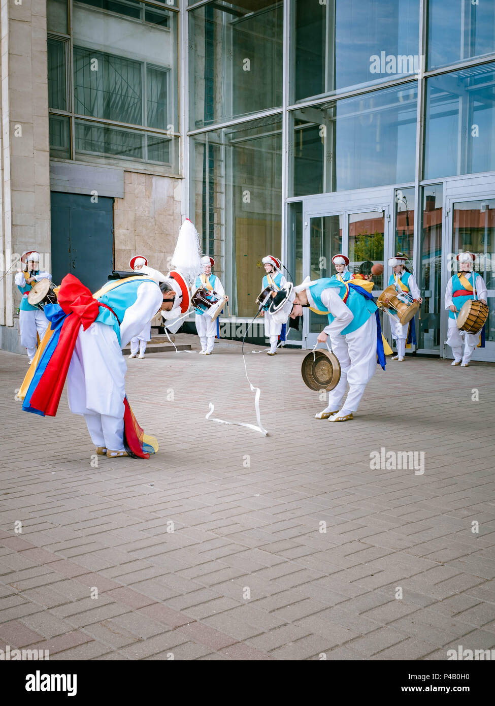 Moscow, Russia, July 12, 2018: Korean traditional percussion musical instruments. A group of musicians and dancers in bright colored suits perform tra Stock Photo