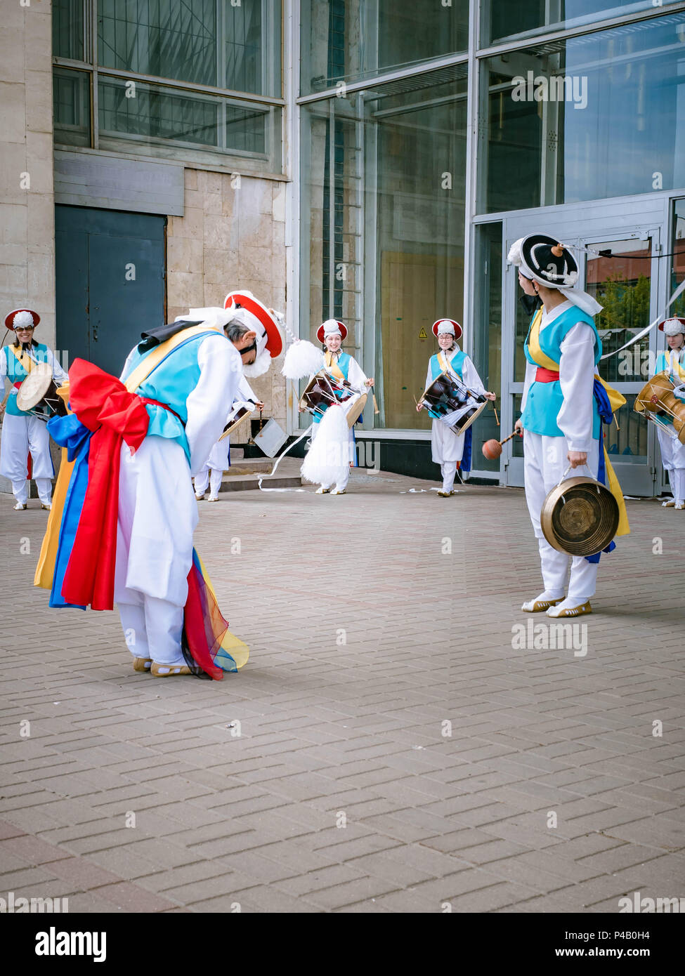 Moscow, Russia, July 12, 2018: Korean traditional percussion musical instruments. A group of musicians and dancers in bright colored suits perform tra Stock Photo