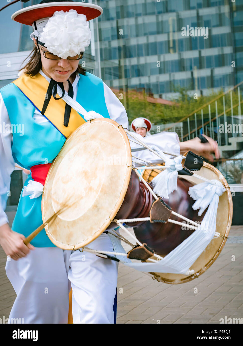 Moscow, Russia, July 12, 2018: Musician play on a Korean traditional percussion musical instrument Janggu double-headed drum with a narrow waist in th Stock Photo