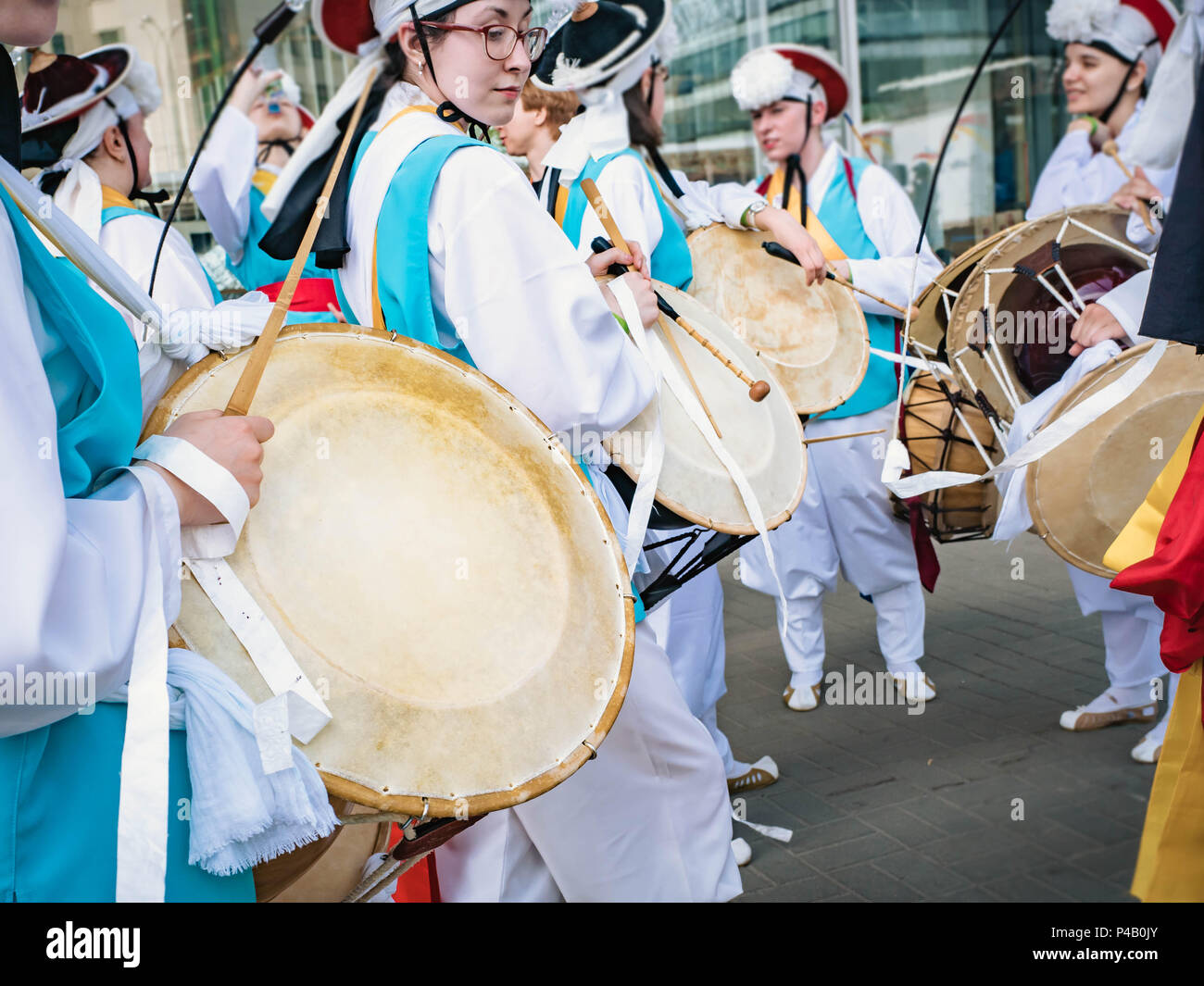 Moscow, Russia, July 12, 2018: Musician play on a Korean traditional percussion musical instrument Janggu double-headed drum with a narrow waist in th Stock Photo