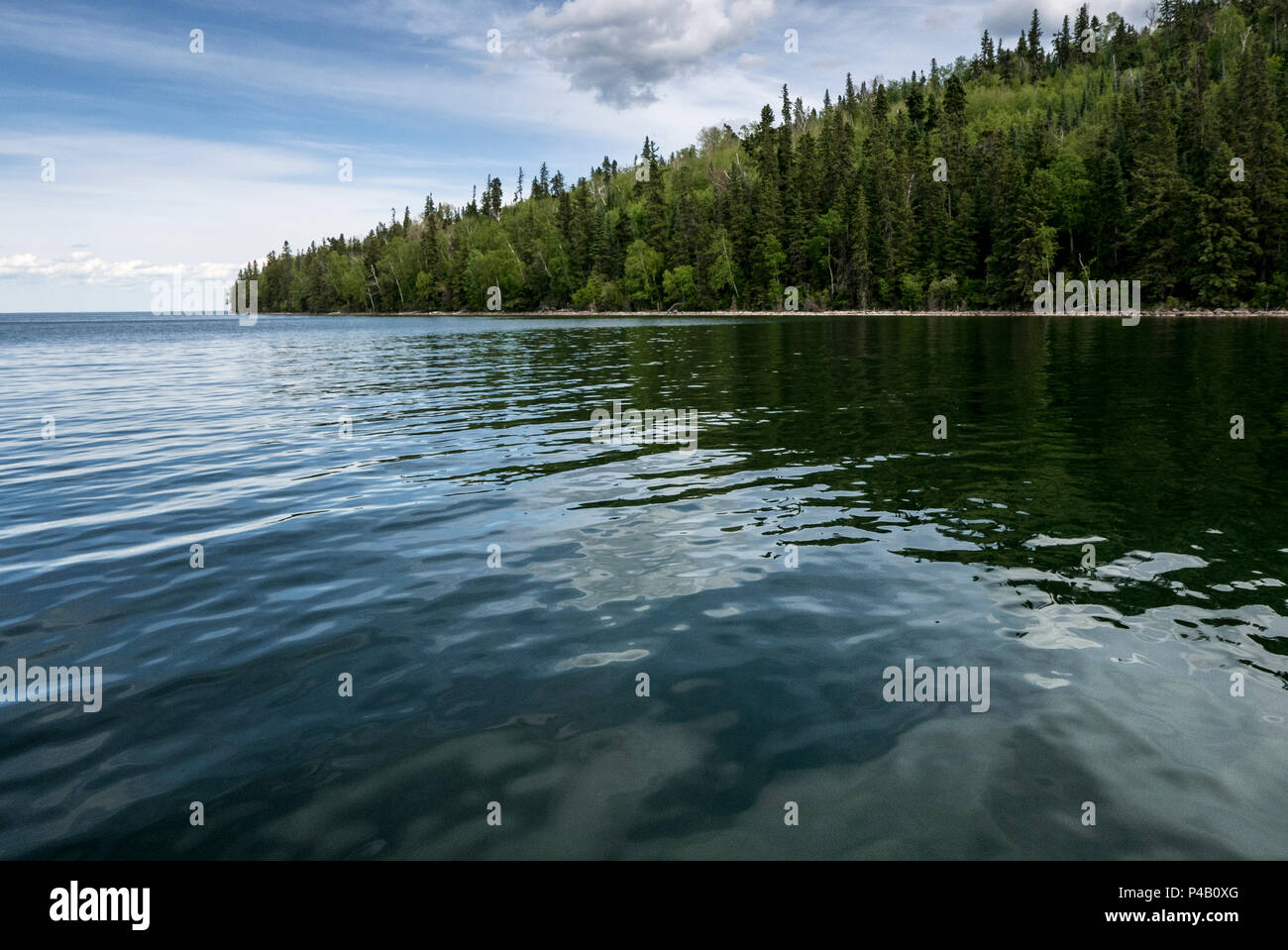 Mirror smooth lake surrounded by forest, Dore Lake, Saskatchewan