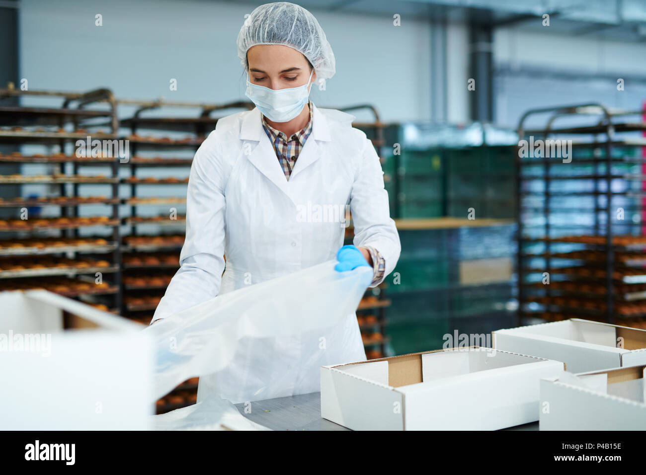 Confectionery factory worker preparing empty boxes Stock Photo Alamy