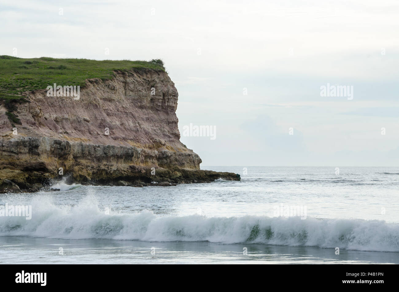 Coastal landscape in Northern Angola with rocky cliff, small waves and white light, N'zeto, Africa. Stock Photo