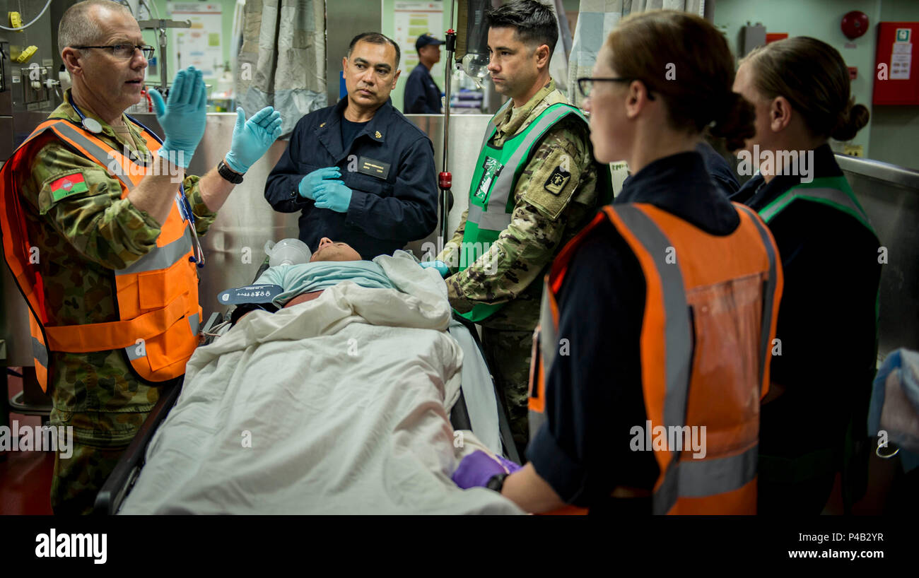 160624-N-QW941-210 PHILIPPINES SEA (June 24, 2016) Capt. William Cater (left), from the Australian Army, a native of Cairns, Australia, instructs personnel during a mass casualty drill aboard hospital ship USNS Mercy (T-AH 19). Deployed in support of Pacific Partnership 2016, medical, engineering and various other personnel embarked aboard Mercy are working side-by-side with partner nation counterparts, exchanging ideas, building best practices and relationships to ensure preparedness should disaster strike. (U.S. Navy photo by Mass Communication Specialist 3rd Class Trevor Kohlrus/Released) Stock Photo