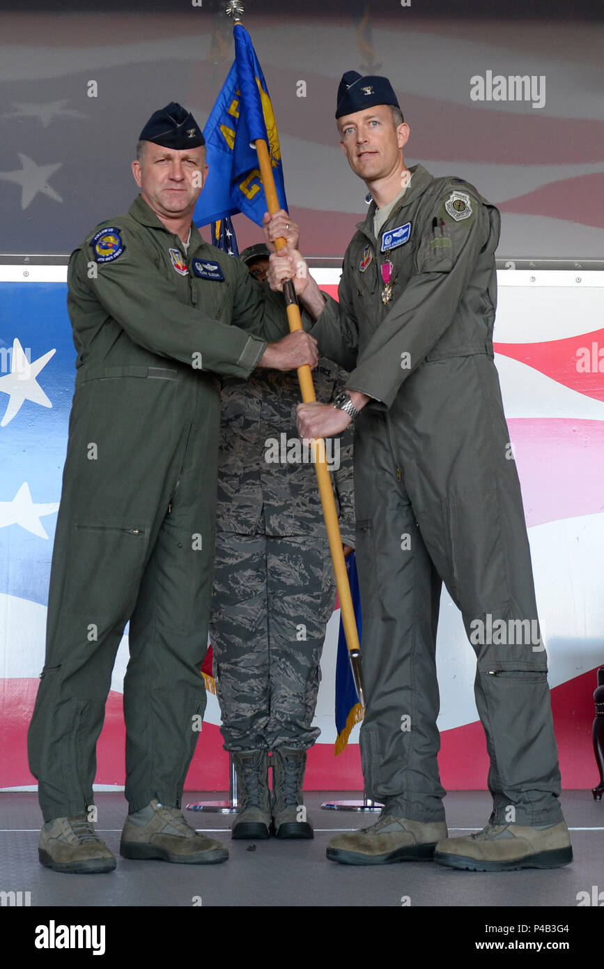 Col. Brian Afflerbaugh, 4th Operations Group commander, passes the guidon to Col. Mark Slocum, 4th Fighter Wing commander, June 20, 2016, at Seymour Johnson Air Force Base, North Carolina. Afflerbaugh departs Seymour Johnson AFB for a command position at Osan Air Base, Republic of Korea. (U.S. Air Force photo by Airman 1st Class Ashley Williamson) Stock Photo