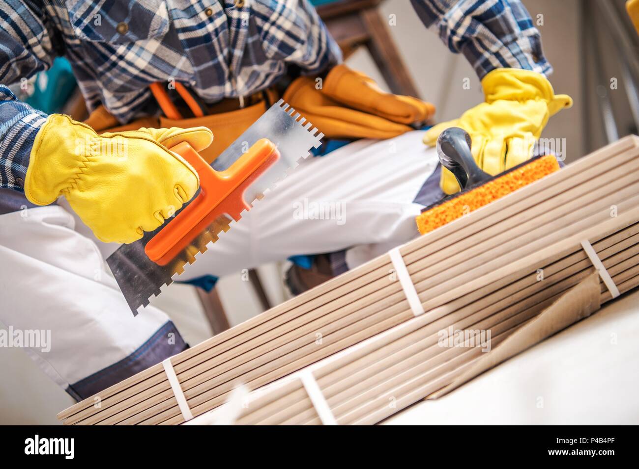 Ceramic Tiles Installer with Construction Tools. Closeup Photo Stock