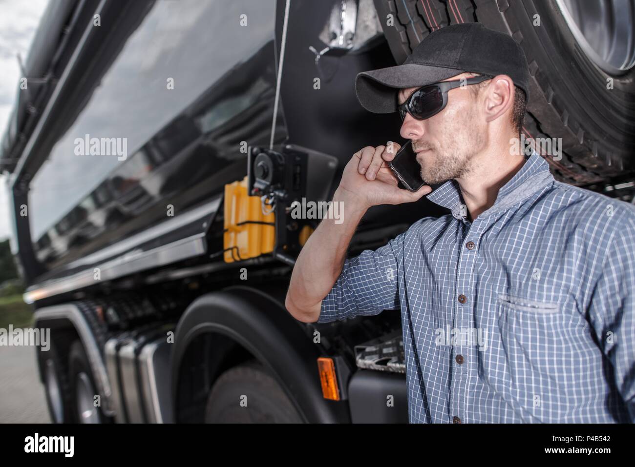 Truck Driver Making Business. Dealing with Potential Clients on the Phone. Heavy Transportation Industry. Stock Photo