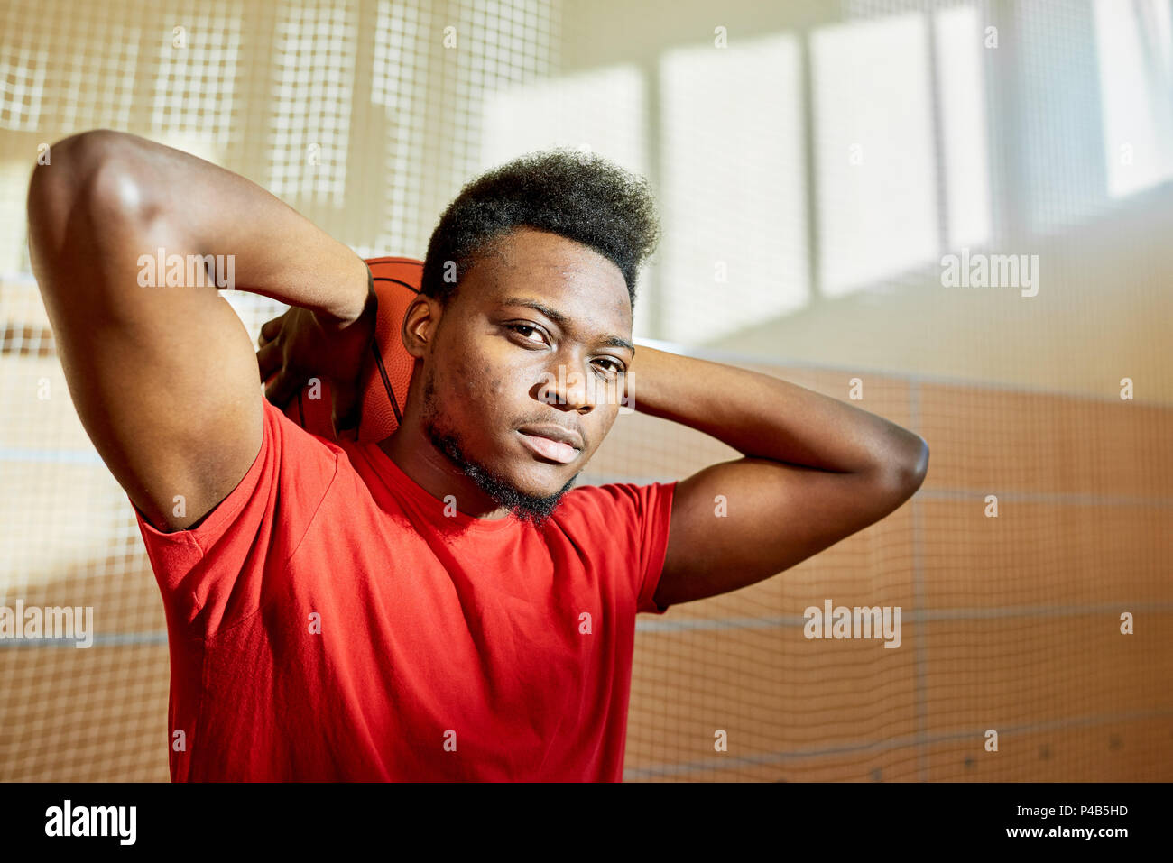 Man holding basketball ball behind head Stock Photo Alamy