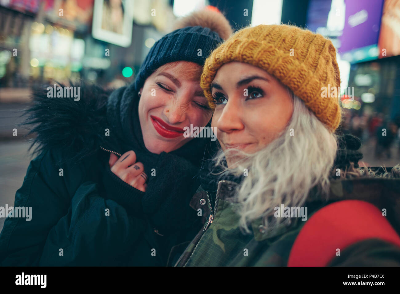 Two girlfriends on times square new york Stock Photo