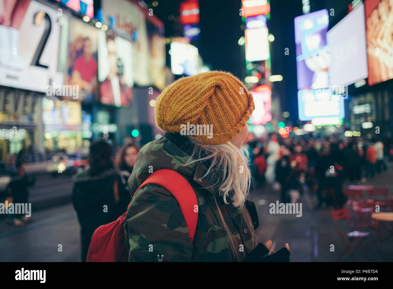 White hair girl with yellow winter hat on times square new york Stock Photo