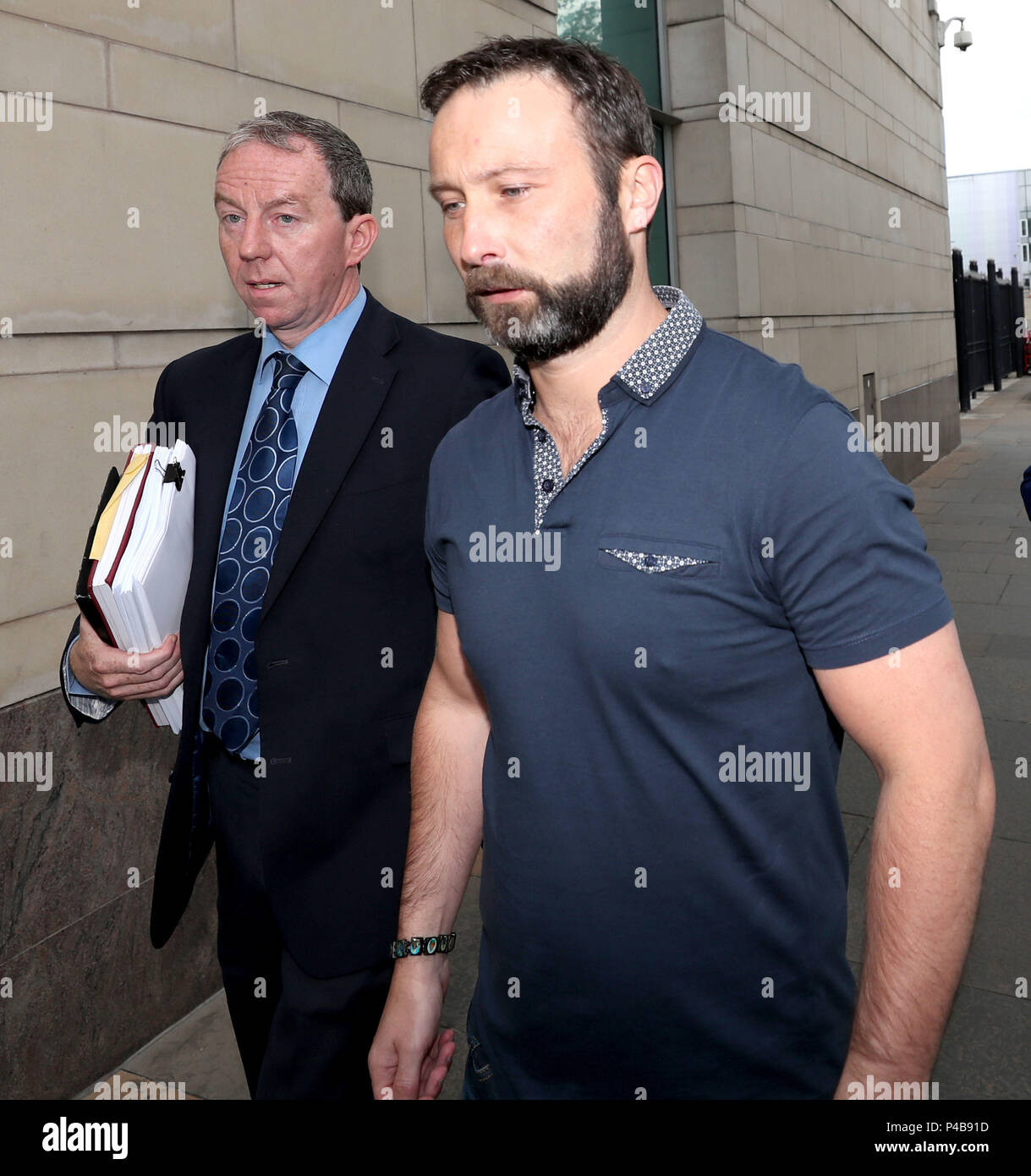 Damien Mclaughlin (right) walks free from Belfast Crown Court, after prosecutors decided not to appeal against a judge's ruling that part of the evidence was unsafe in the trial over the killing of prison officer David Black. Stock Photo