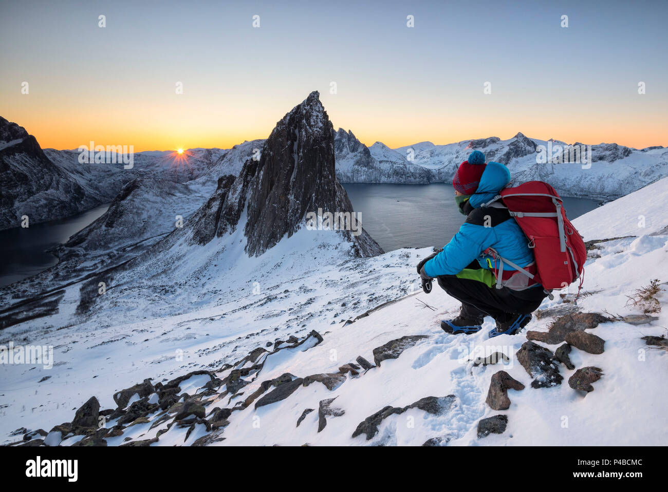 Hikers watch the first sun that it hits the peak called Segla, Hesten,  Fjordgard, Mefjorden, Senja, Tromso, Norway, Europe Stock Photo - Alamy