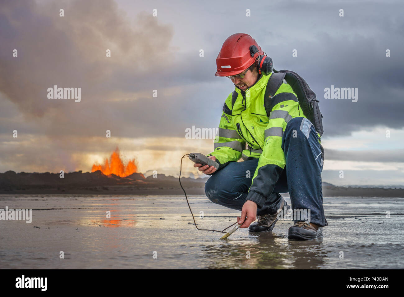 Scientist taking measurements by the eruption site at Holuhraun, near Bardabunga Volcano, Iceland. August 29, 2014 a fissure eruption started in Holuhraun at the northern end of a magma intrusion, which had moved progressively north, from the Bardarbunga volcano. Bardarbunga is a stratovolcano located under Vatnajokull, Iceland's most extensive glacier. Picture Date-Sept. 2, 2014 Stock Photo