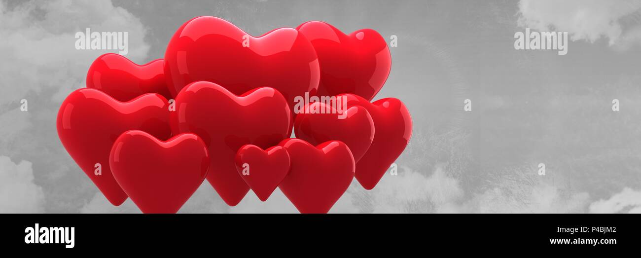 Composed image of red heart balloons on grey sky background Stock Photo