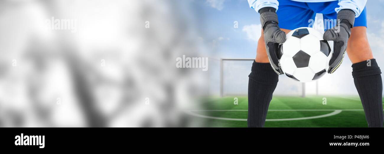 Soccer goalkeeper holding ball in goal with transition Stock Photo
