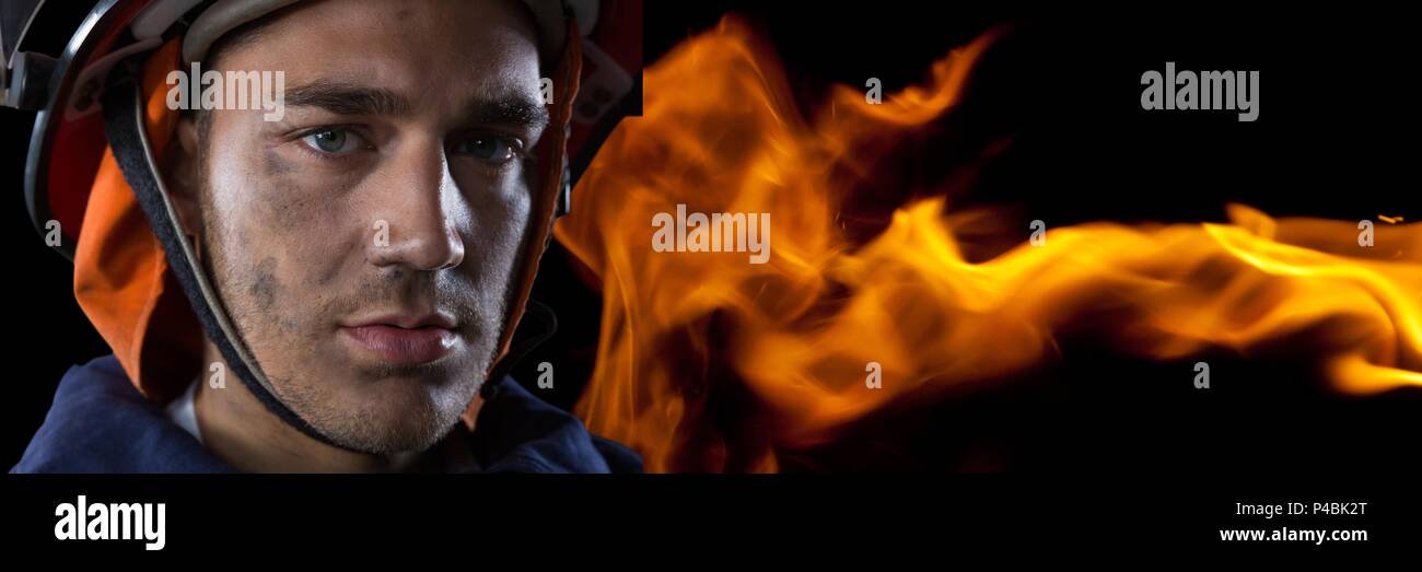 Composite image of firefighter with fire background Stock Photo