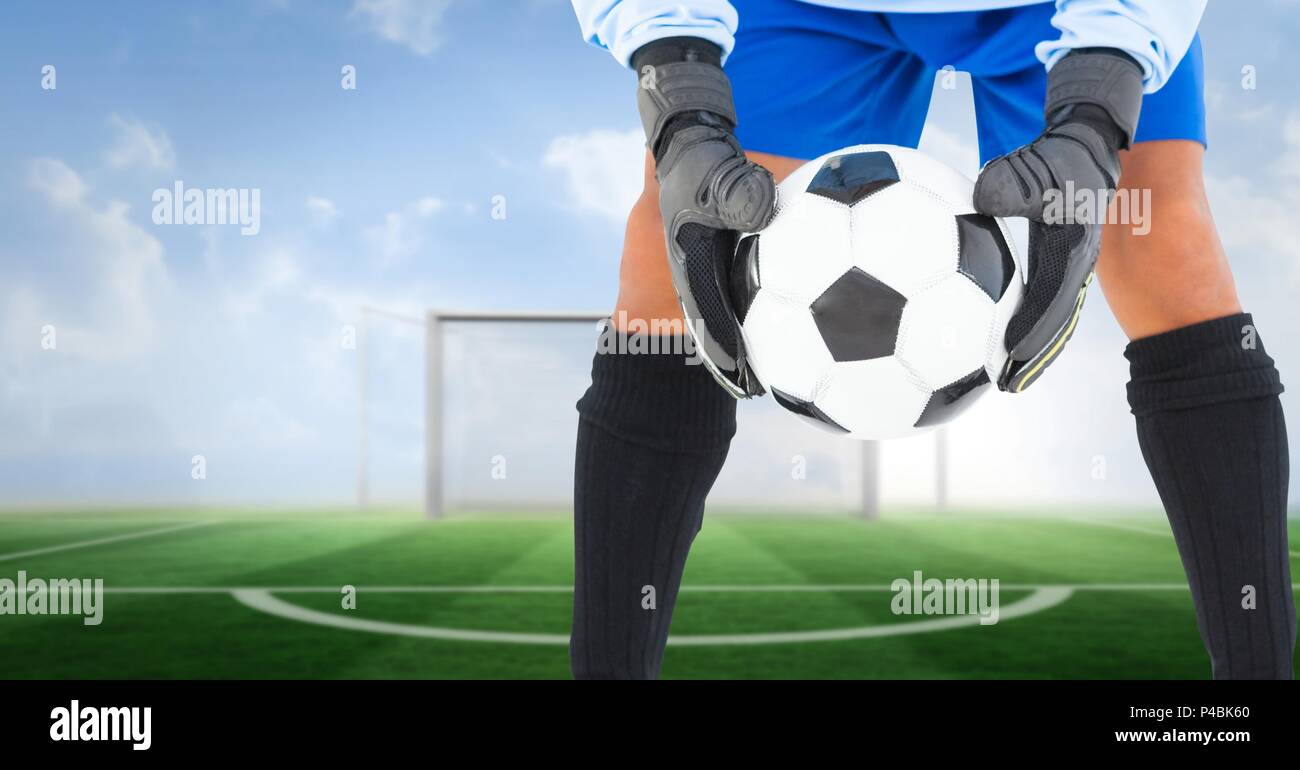 Soccer goalkeeper holding ball in goal Stock Photo