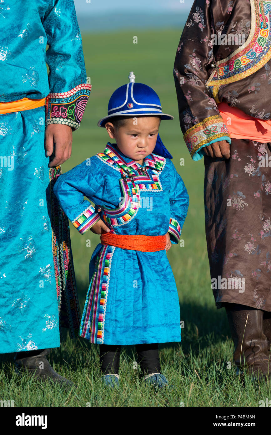 Wearing traditional Mongolian dress, a young boy pridefully stands with  older family members, Xilinhot, Inner Mongolia, China Stock Photo - Alamy