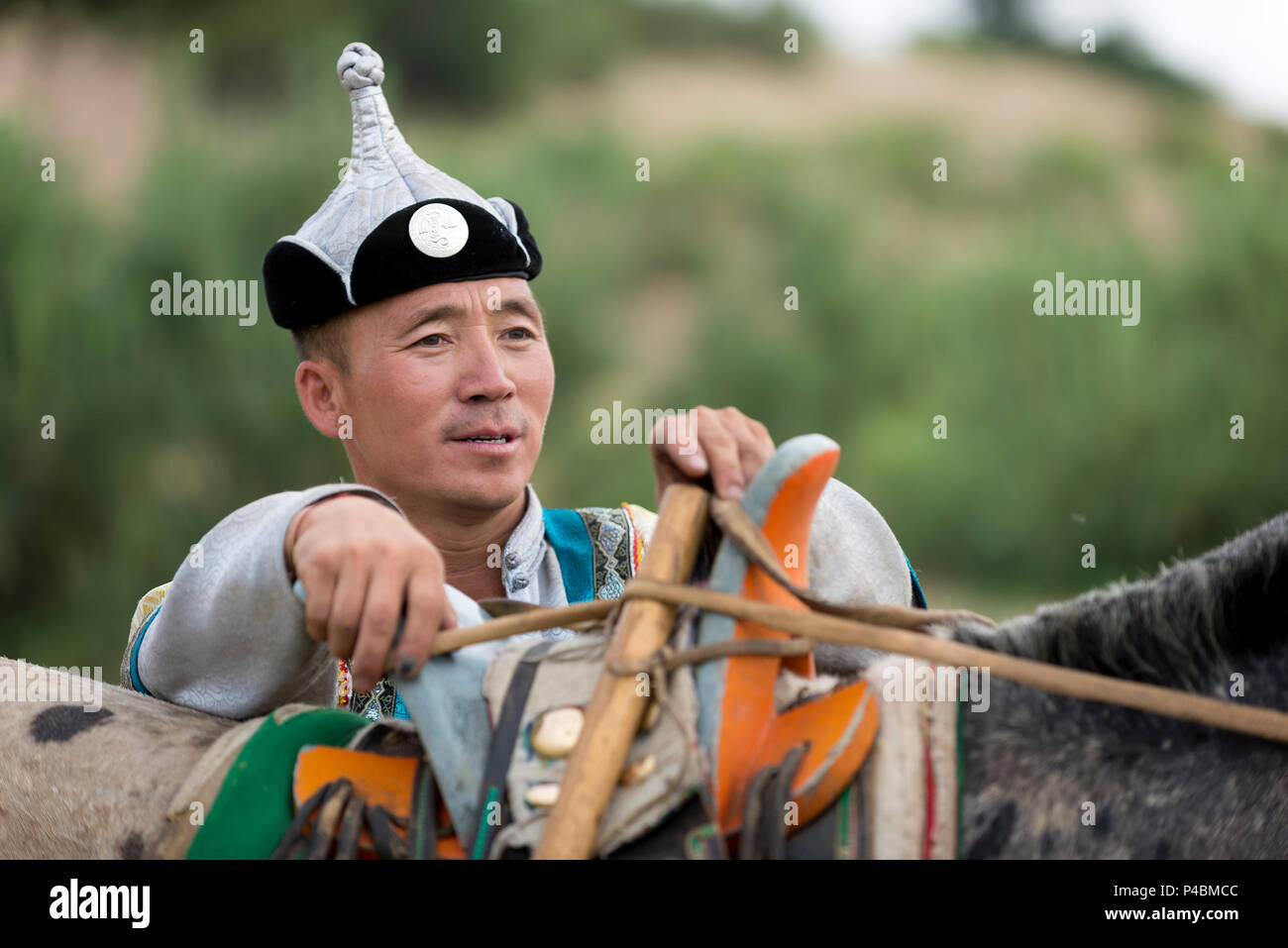 Horsemen dressed in traditional costume prepares to herd horses, Xilinhot, Inner Mongolia, China, Inner Mongolia, China Stock Photo