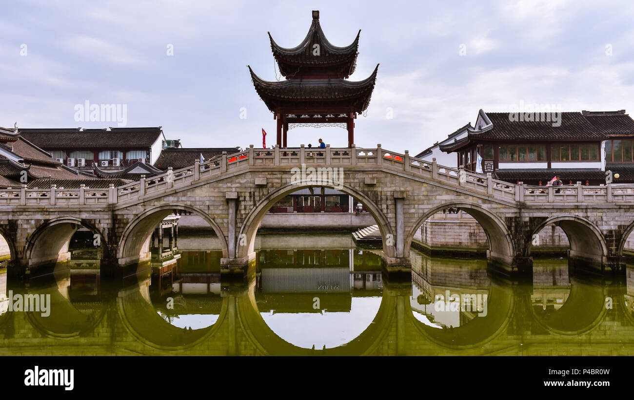 Multiple arches stone bridge with pagoda pavilion on top, Wuxi, Jiangsu, China. Stock Photo