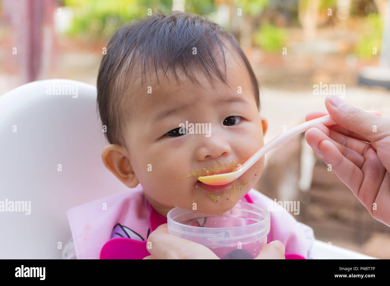 Asian cute baby eating food, Mother feeding soup for young kid seven