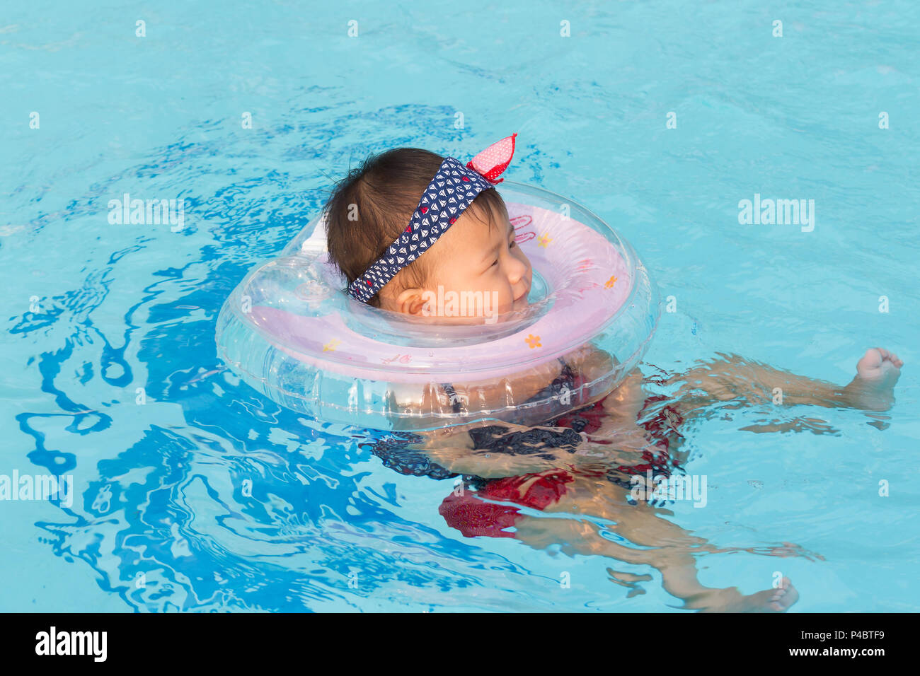 Asian cute eight month baby enjoy swimming pool, Active healthy first