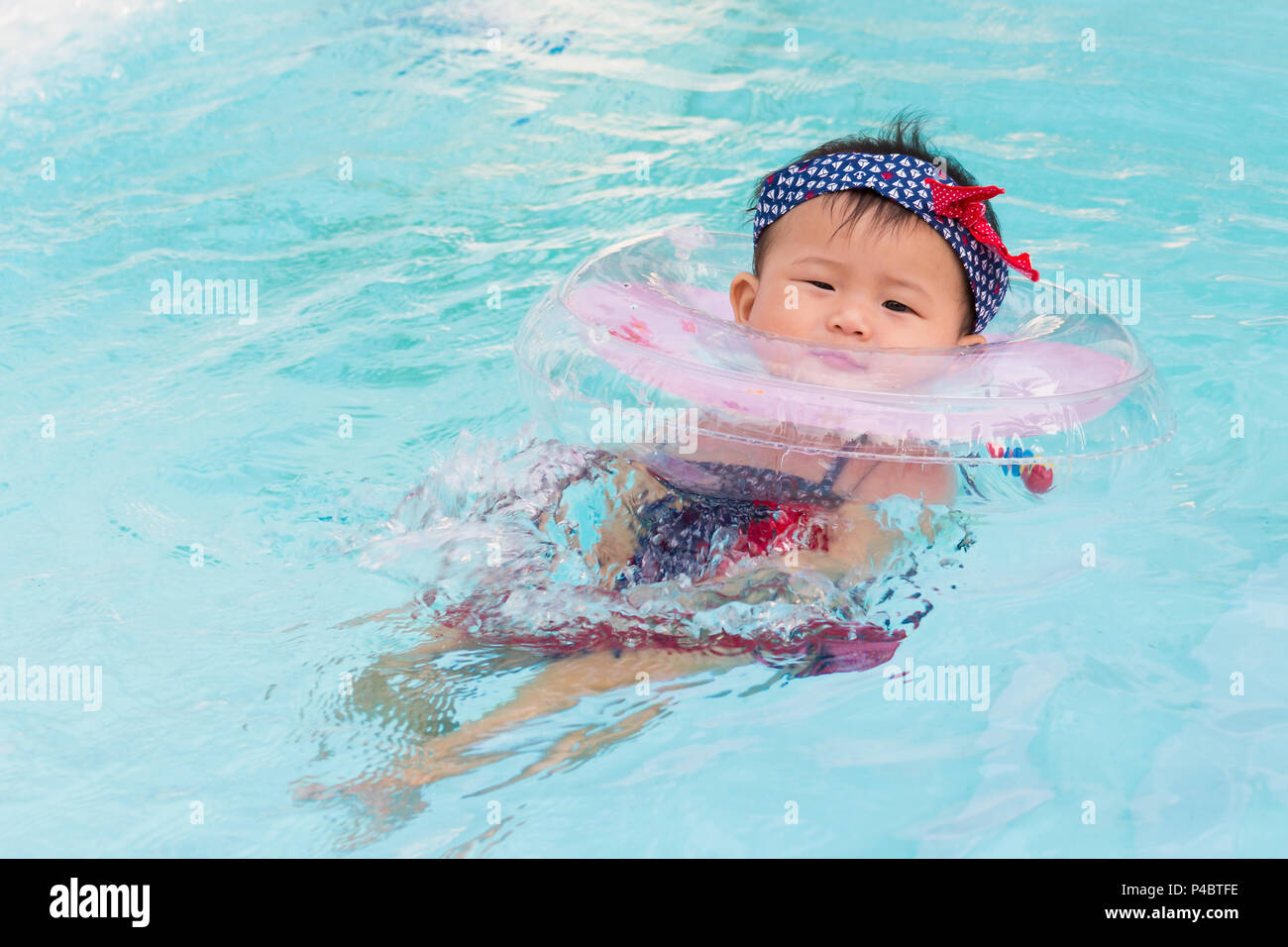 Asian cute eight month baby relax swimming pool, Active healthy first