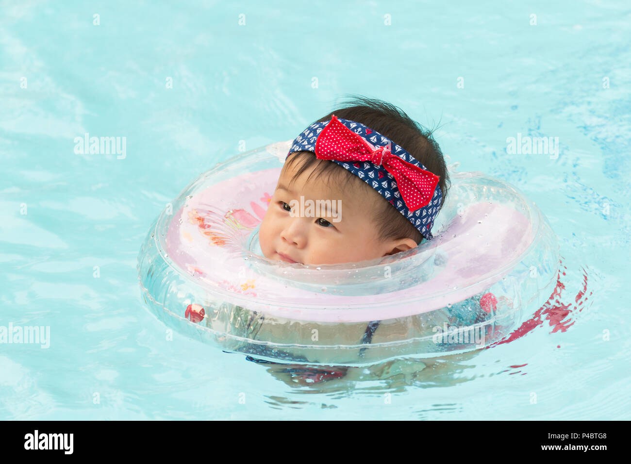 Asian cute eight month baby playing swimming pool, Active healthy first
