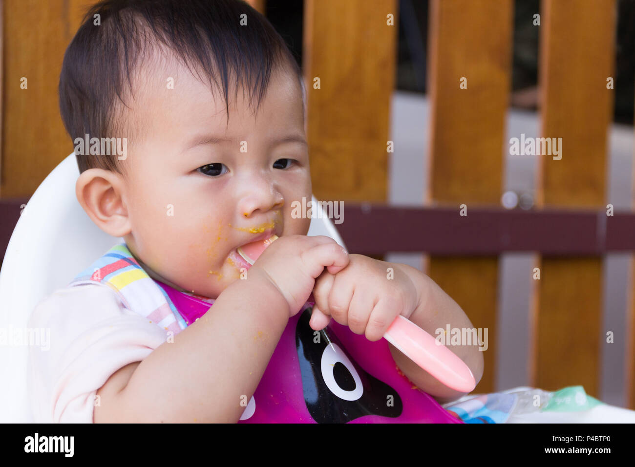 Asian cute baby enjoying food, Mother feeding food for young kid eight