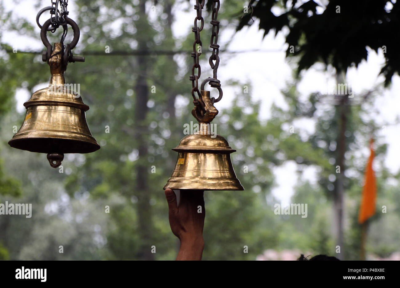 India. 20th June, 2018. Hindu devotee ringing the bell spring during ...