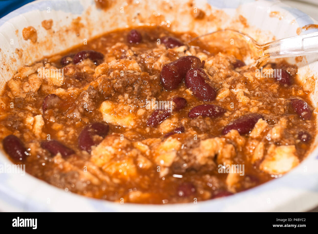 Messy plate with splattered wholesome bean stew and vegetables in a close up view Stock Photo