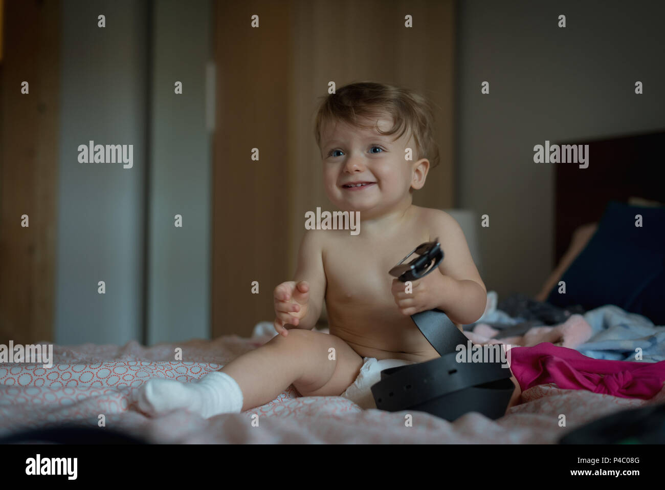Baby boy playing on bed Stock Photo