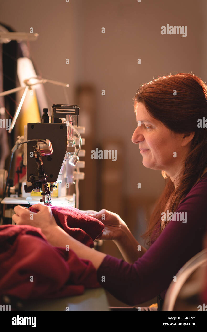 Tailor sewing cloth with sewing machine Stock Photo Alamy