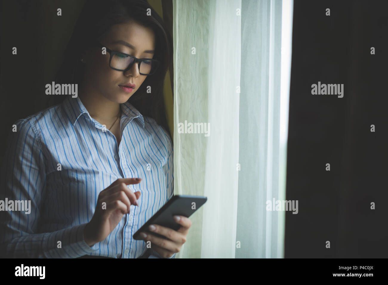 Businesswoman using mobile phone Stock Photo