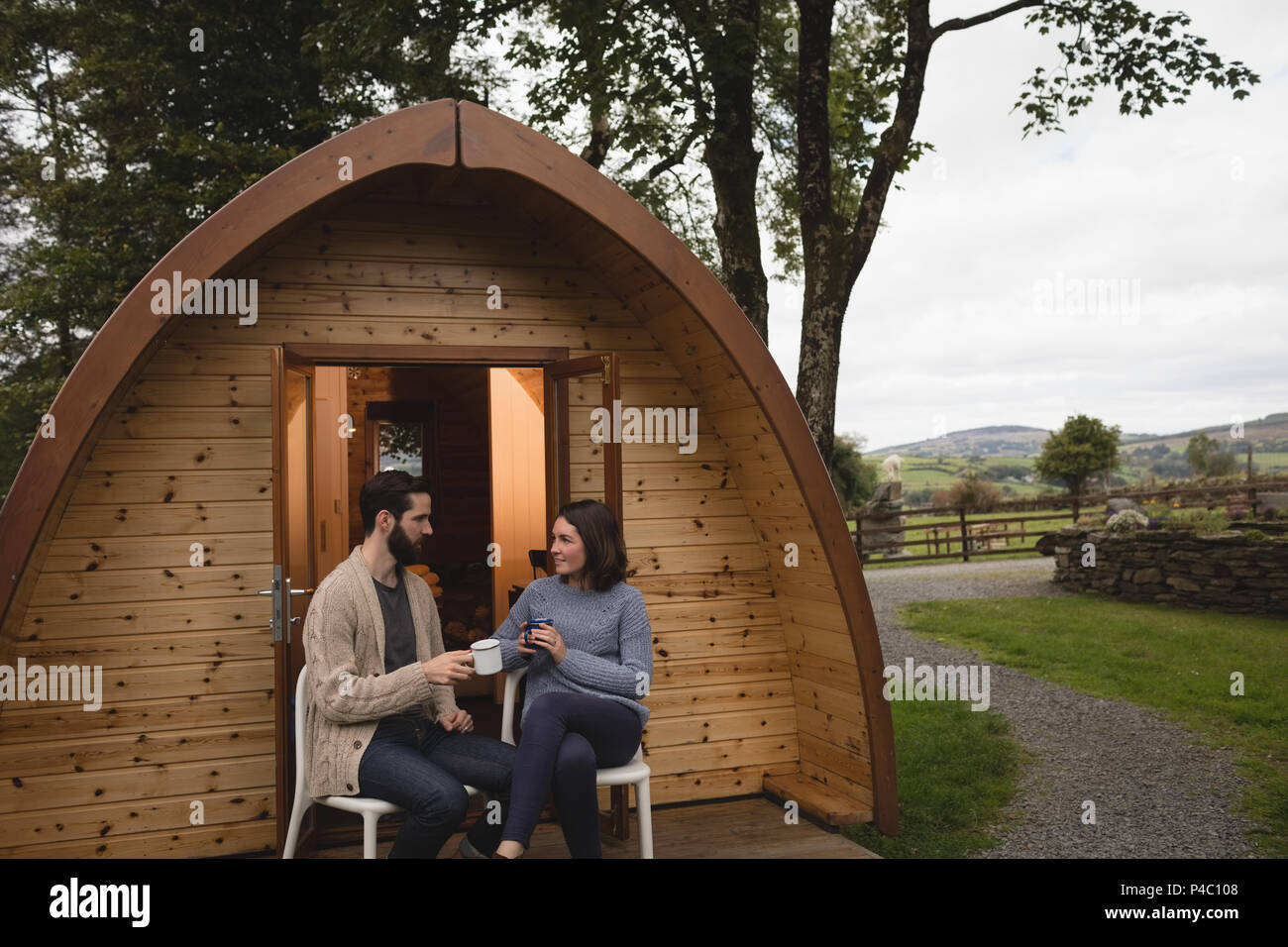 Couple relaxing in log cabin Stock Photo