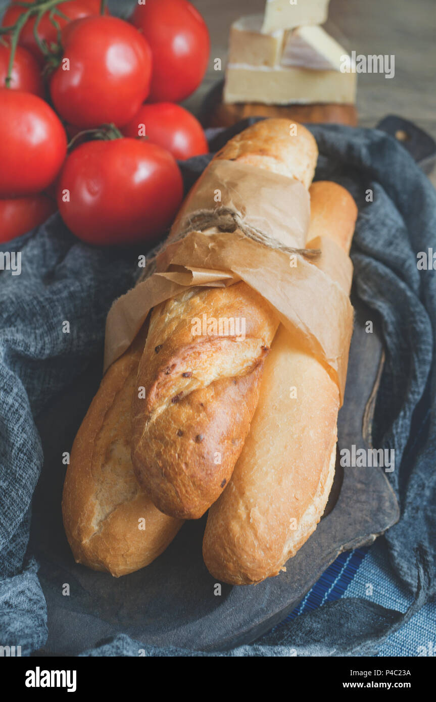 Baguette sandwich with lettuce and slices of fresh tomato. Preparation