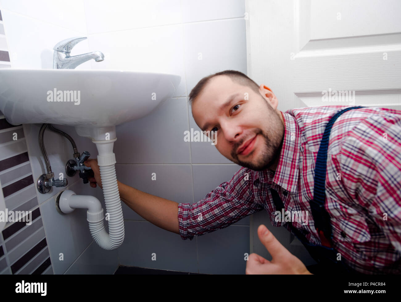 Handyman fixing the sink in the toilet Stock Photo Alamy