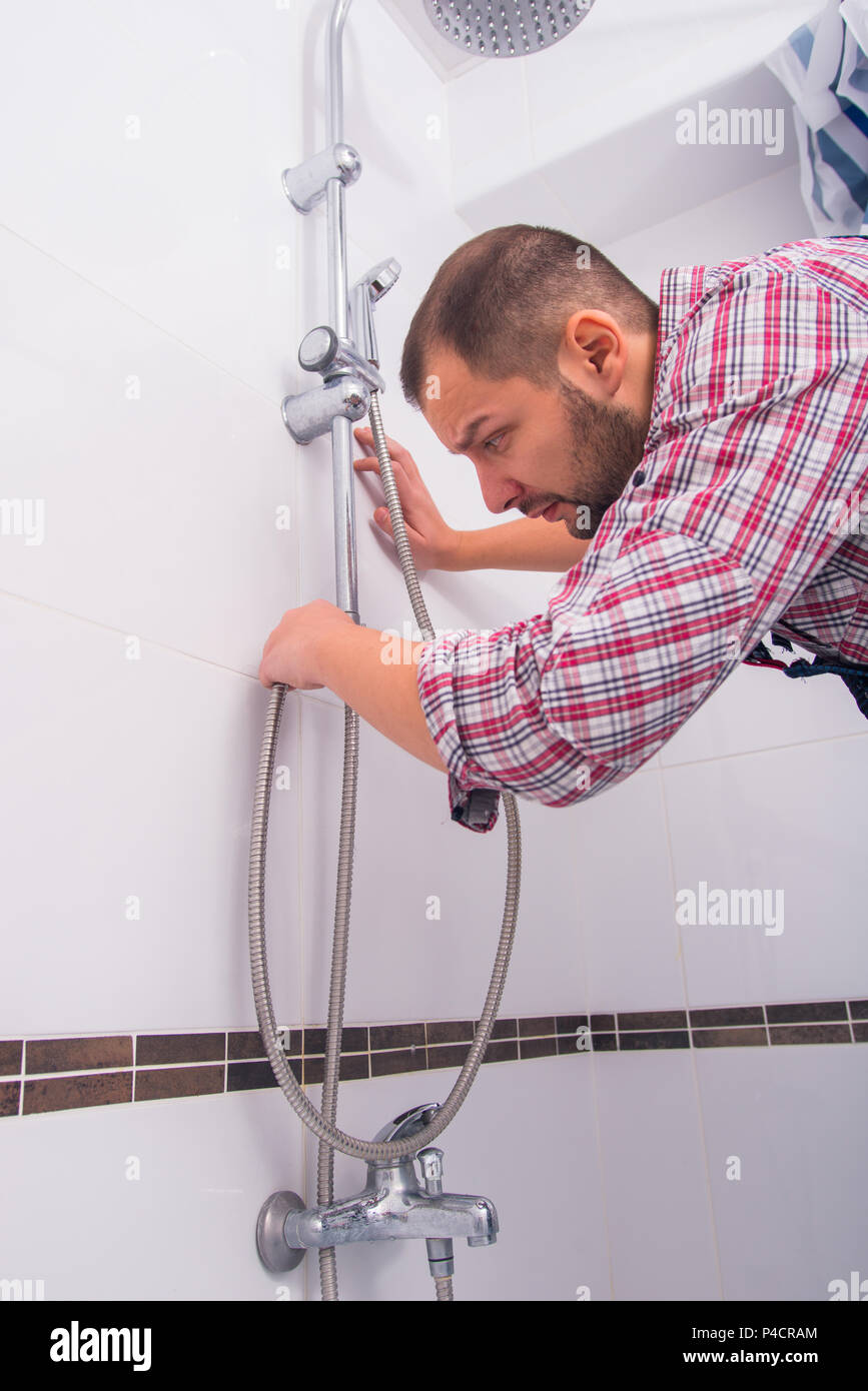 Handyman fixing the shower the bathroom Stock Photo Alamy