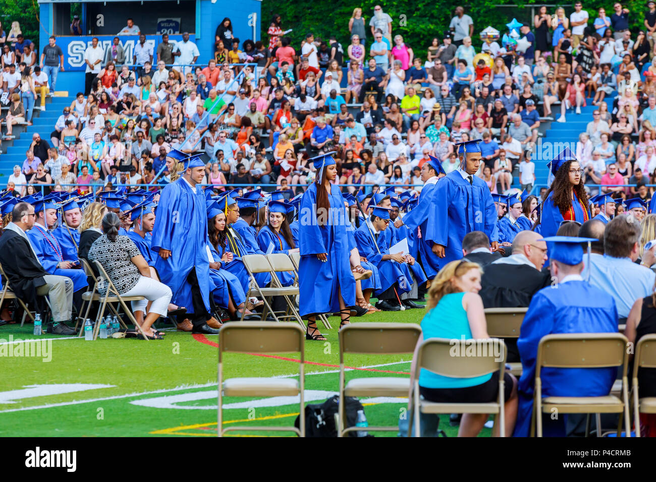 Crowd image of students at graduation ceremony from behind Stock Photo