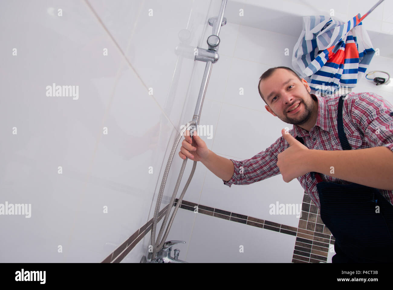 Handyman fixing the shower the bathroom Stock Photo Alamy
