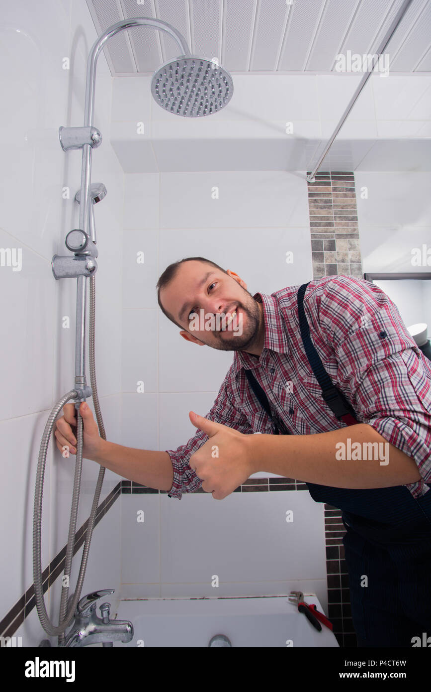 Handyman fixing the shower the bathroom Stock Photo Alamy