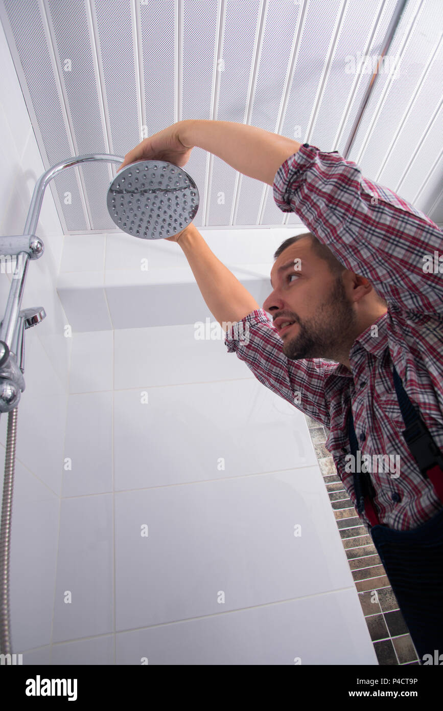Handyman fixing the shower the bathroom Stock Photo Alamy