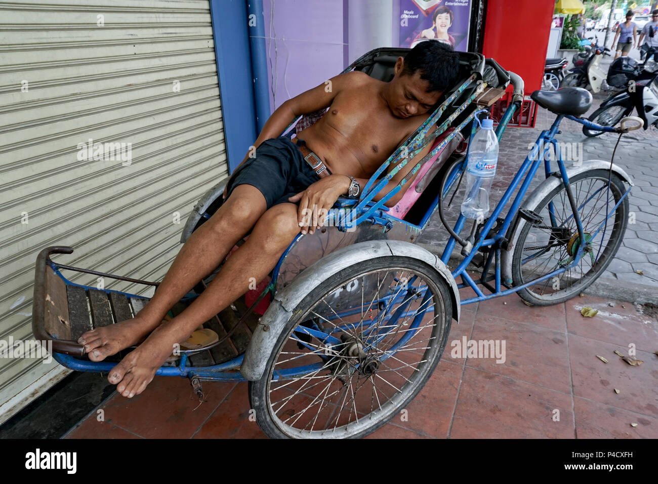 man sleeping in tuk tuk, Phnom Penh, Cambodia Stock Photo
